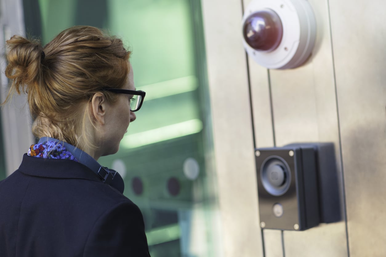 woman entering building using electronic security